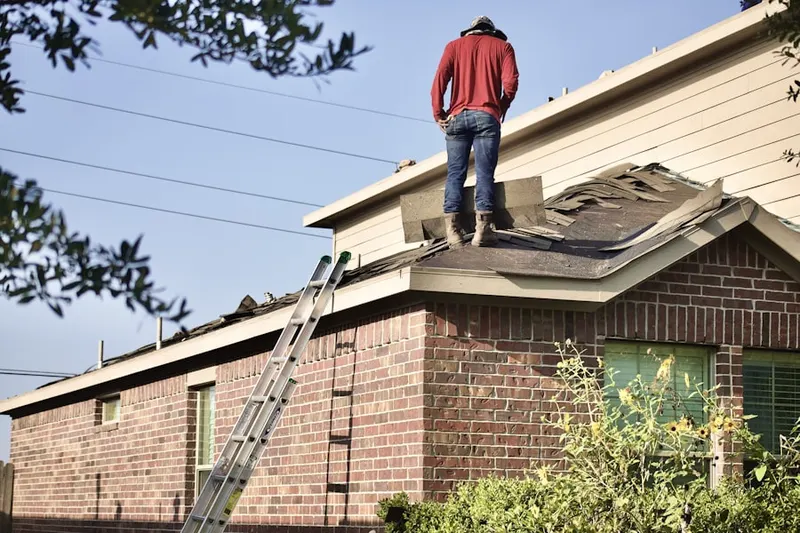 Professional roofer working on a residential roof in Cedar Riverside